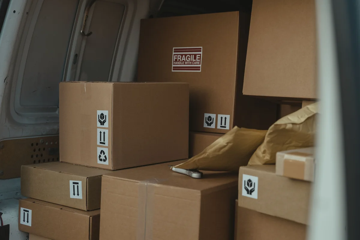 Cardboard parcels stacked inside a delivery van